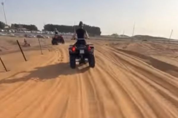 Buggy racing across desert dunes